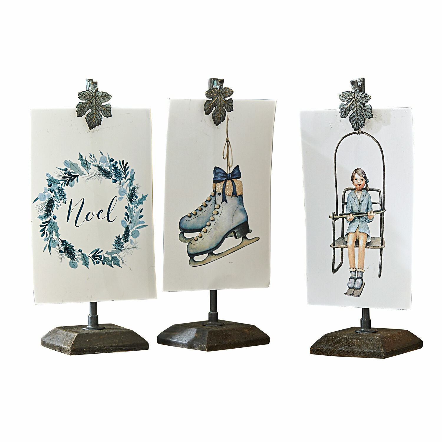 Lot de 3 images avec support Herveline Trois décorations de Noël sur socles avec pinces en métal, motifs patins, fille et inscription Noel