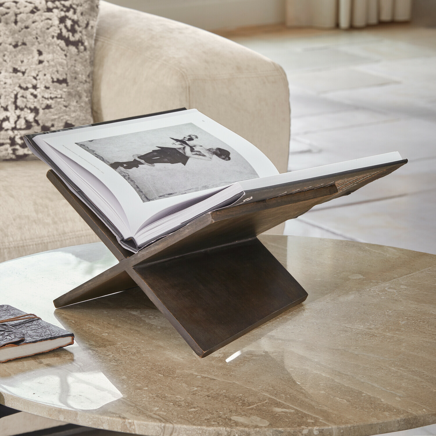 Présentoir à livre Rialenca Support à livre en bois foncé sur table en marbre dans un salon, accessoire déco pratique