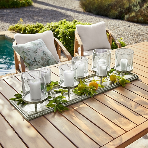 Bougeoir décoratif en bois et verre pour 6 bougies sur table de jardin, style naturel avec feuillage vert