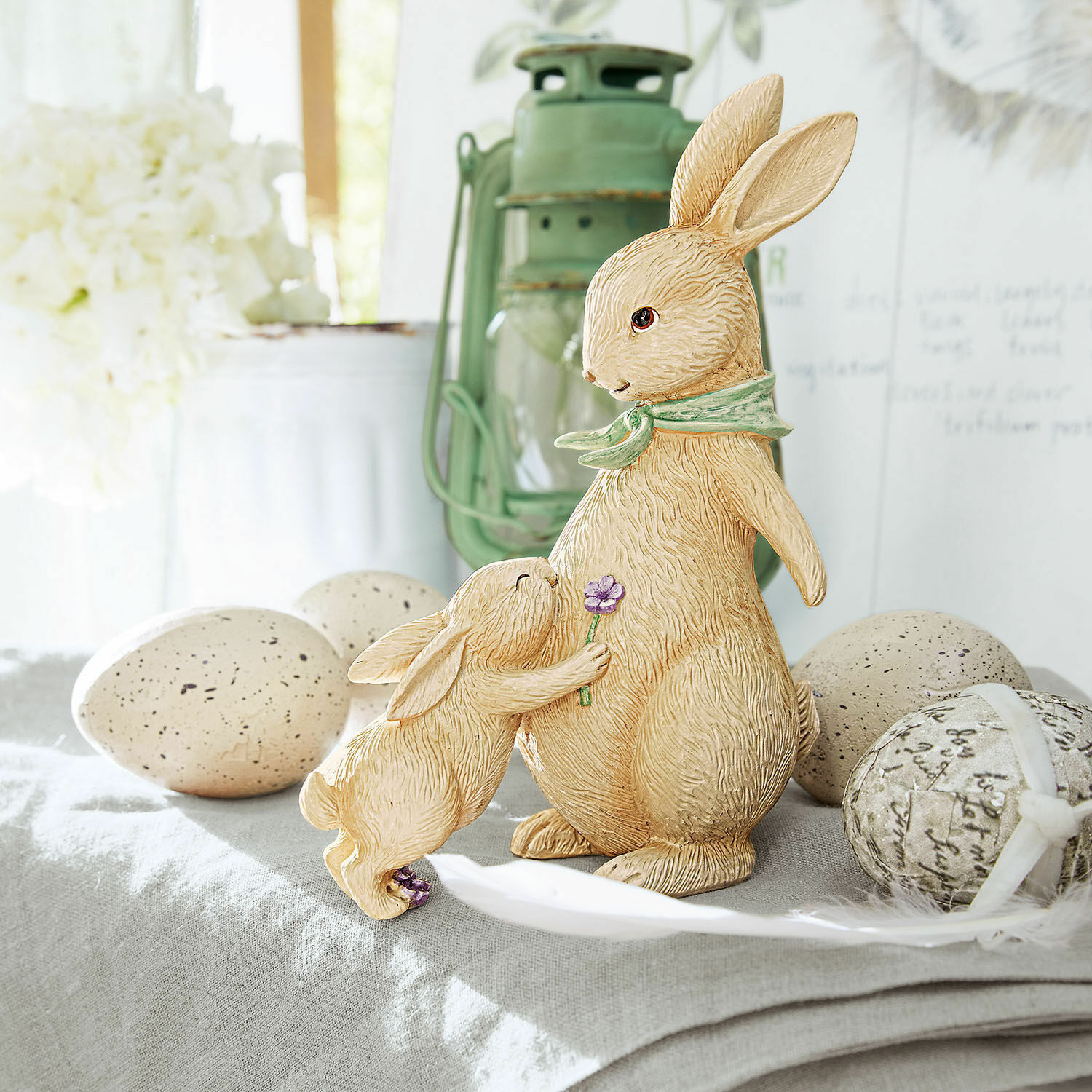 Lapins décoratifs Susans Figurines de lapins en résine beige sur une table décorative avec des œufs de Pâques