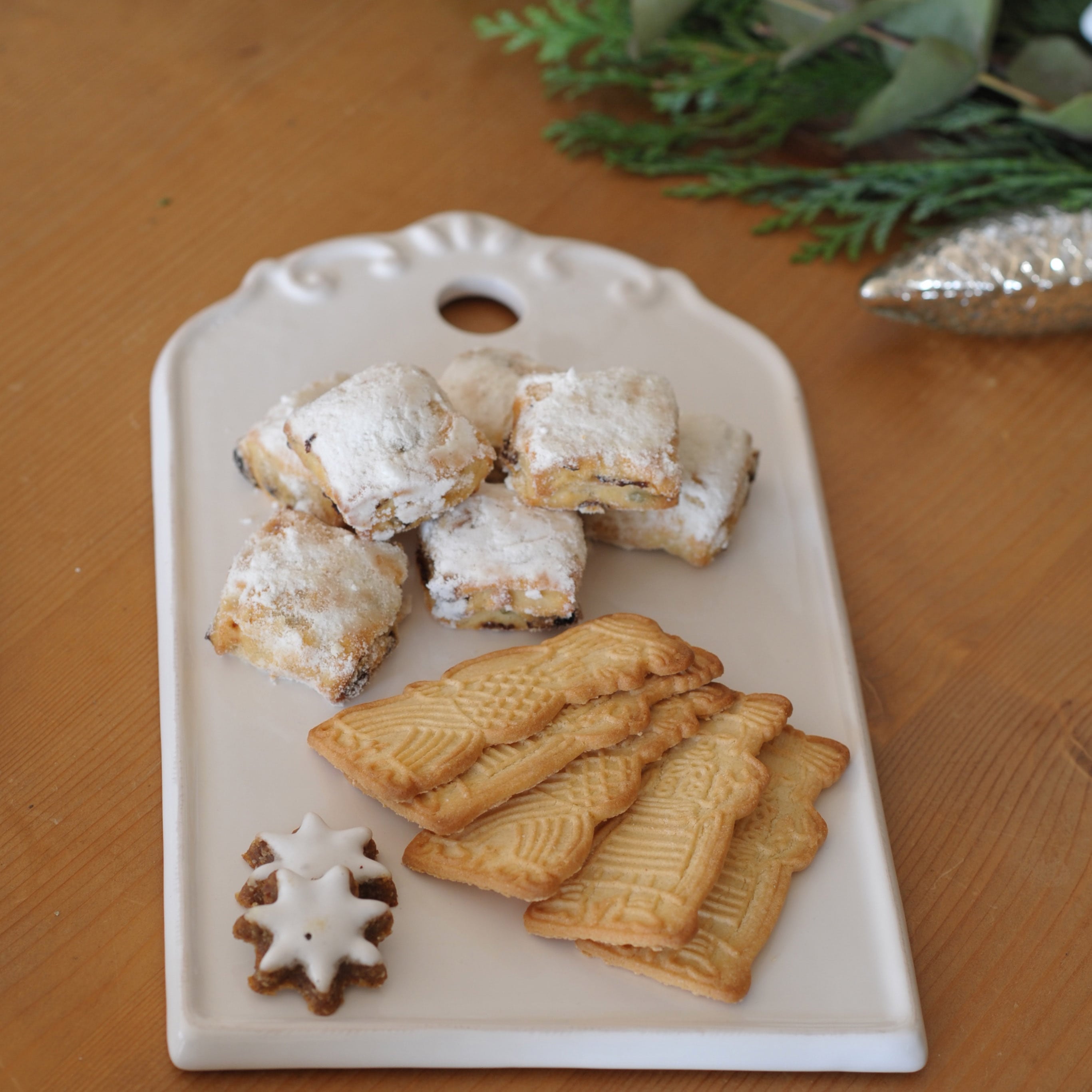Plateau en céramique blanche avec biscuits de Noël traditionnels sur table en bois