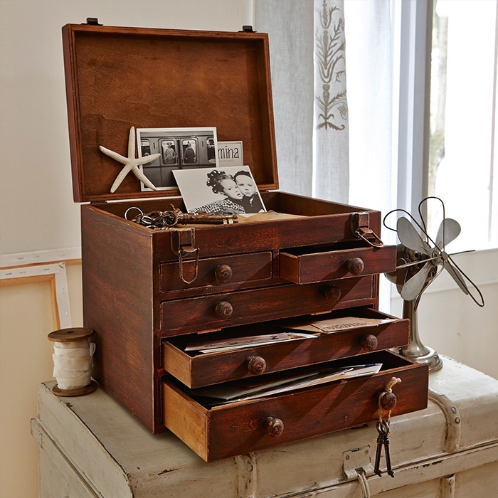 Coffre en bois avec tiroirs ouverts et couvercle relevé, décorations et photos, meuble de rangement vintage