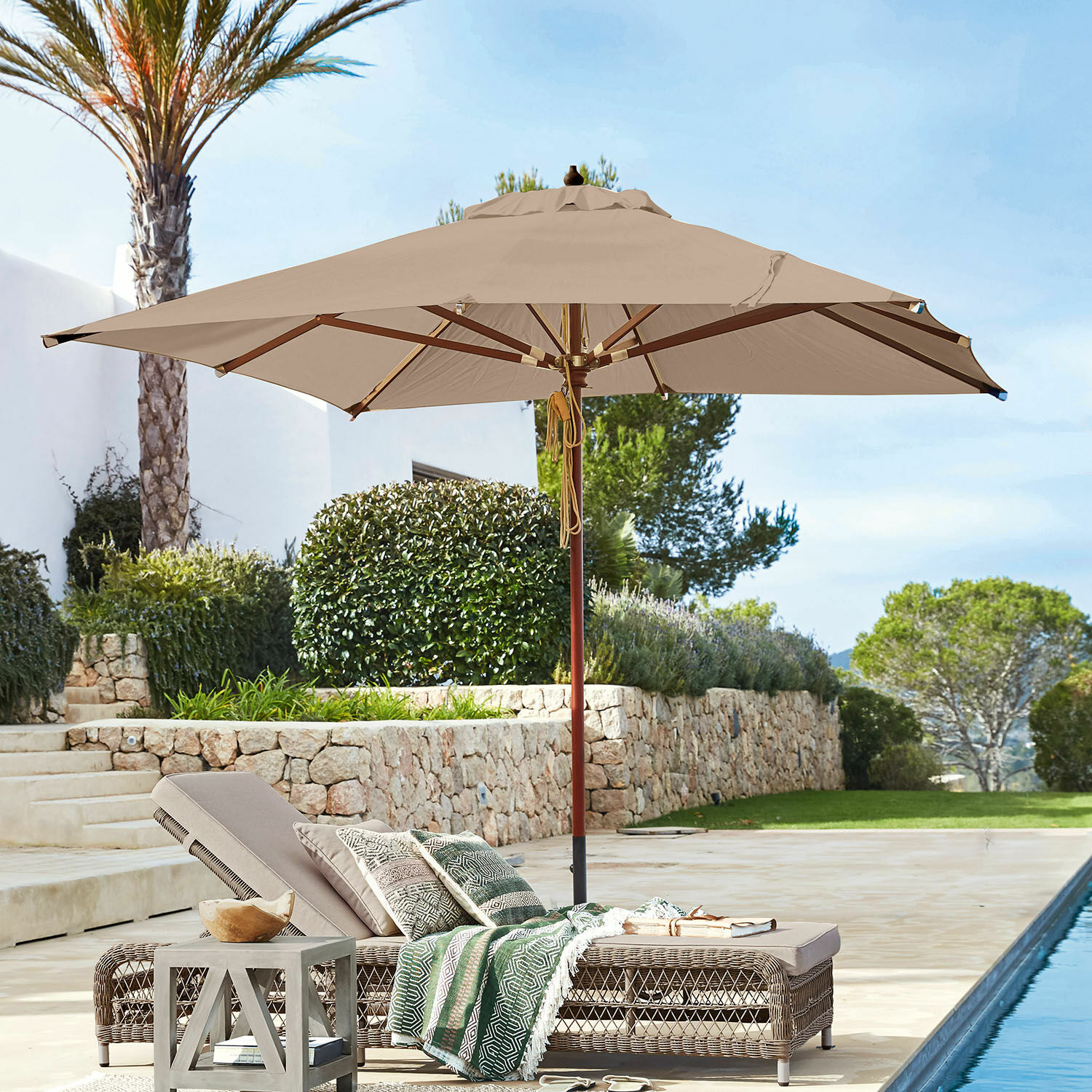 Parasol Barnet Parasol de jardin beige avec structure en bois au-dessus d'une chaise longue en rotin près de la piscine