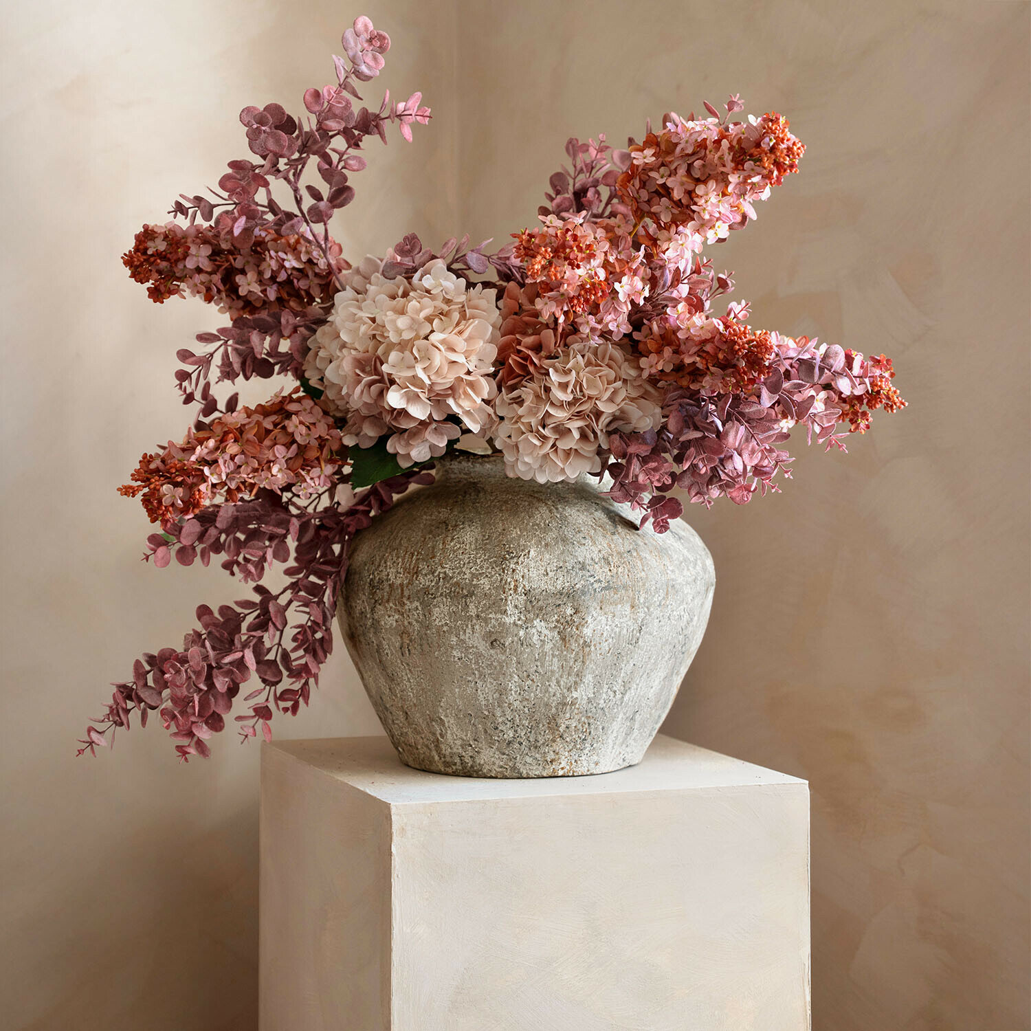 Vase rustique en pierre avec fleurs décoratives roses et beige pour décoration intérieure