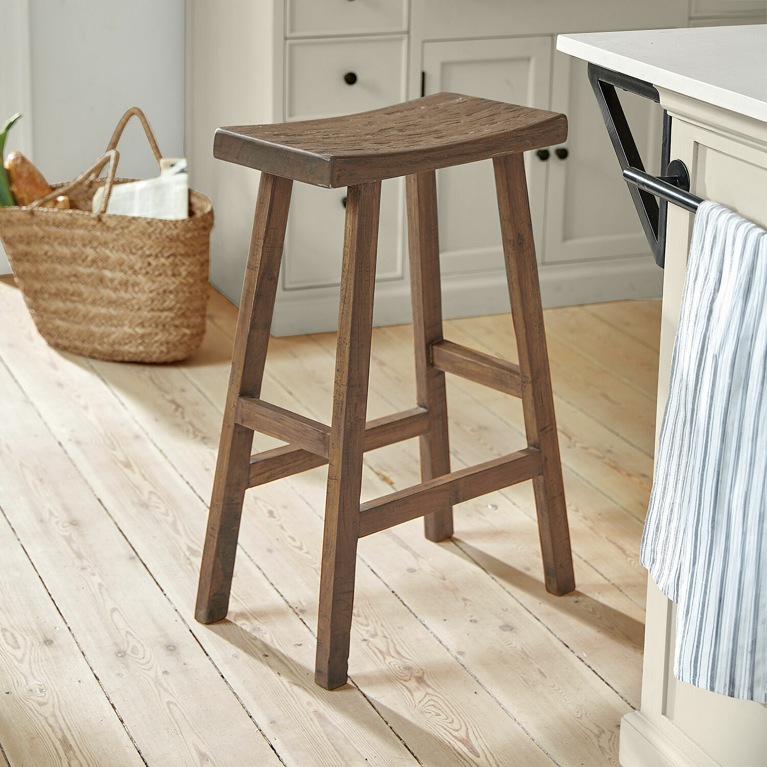 Tabouret Nael Tabouret de bar en bois marron sur un sol clair dans une cuisine moderne