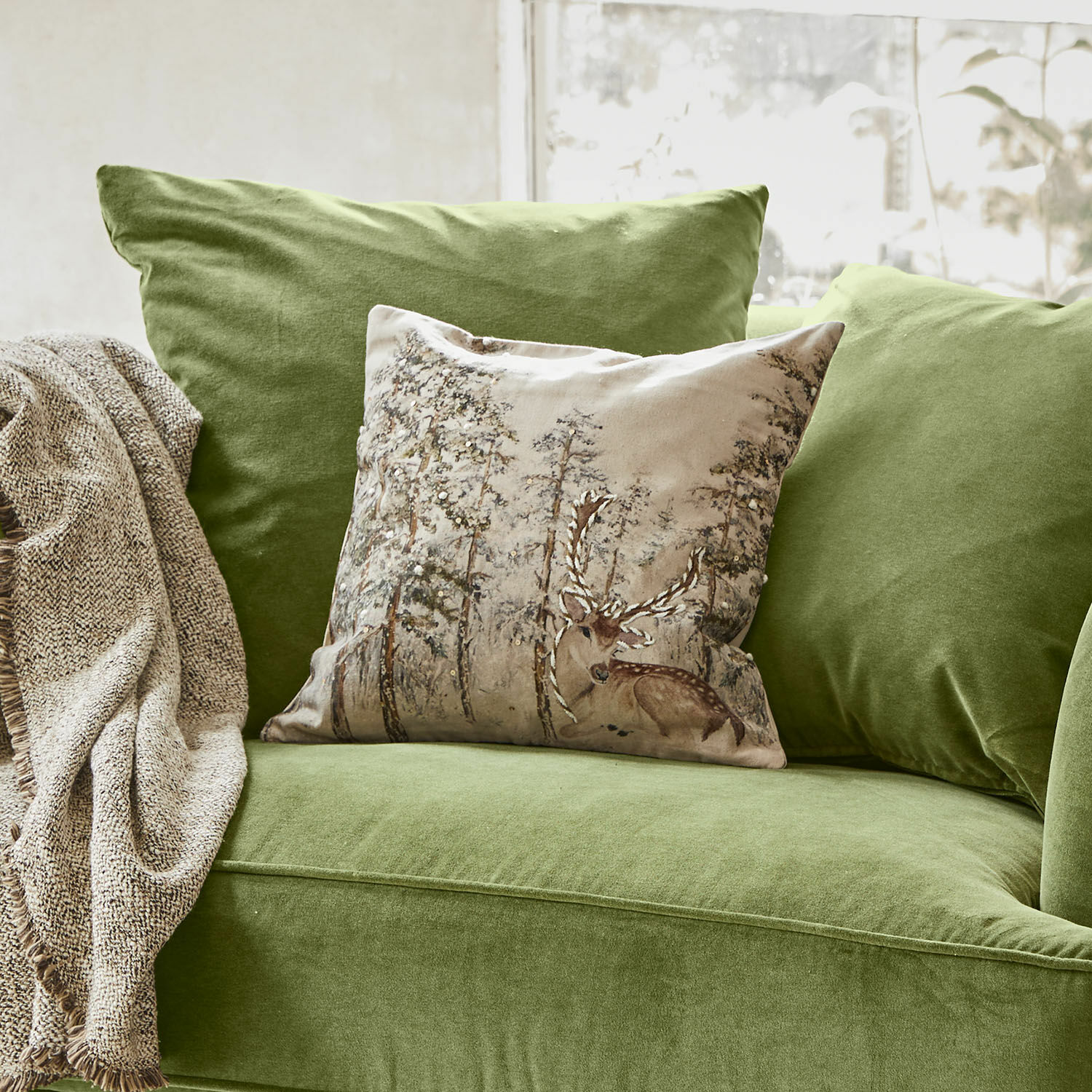 Housse de coussin Valoisin Canapé vert en velours avec coussin décoratif motif cerf et plaid beige pour salon cosy