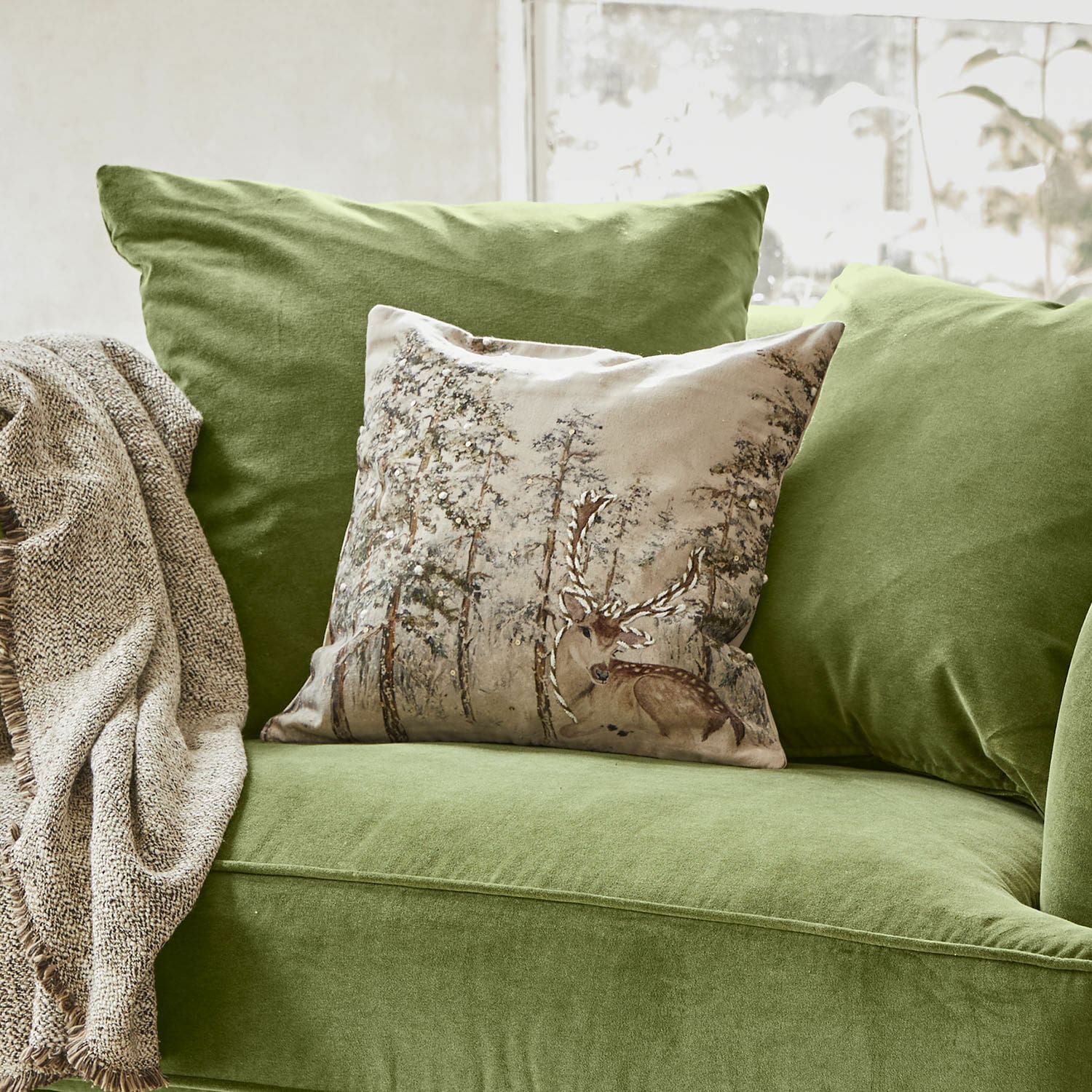 Housse de coussin Valoisin Canapé vert en velours avec coussin décoratif motif cerf et plaid beige pour salon cosy