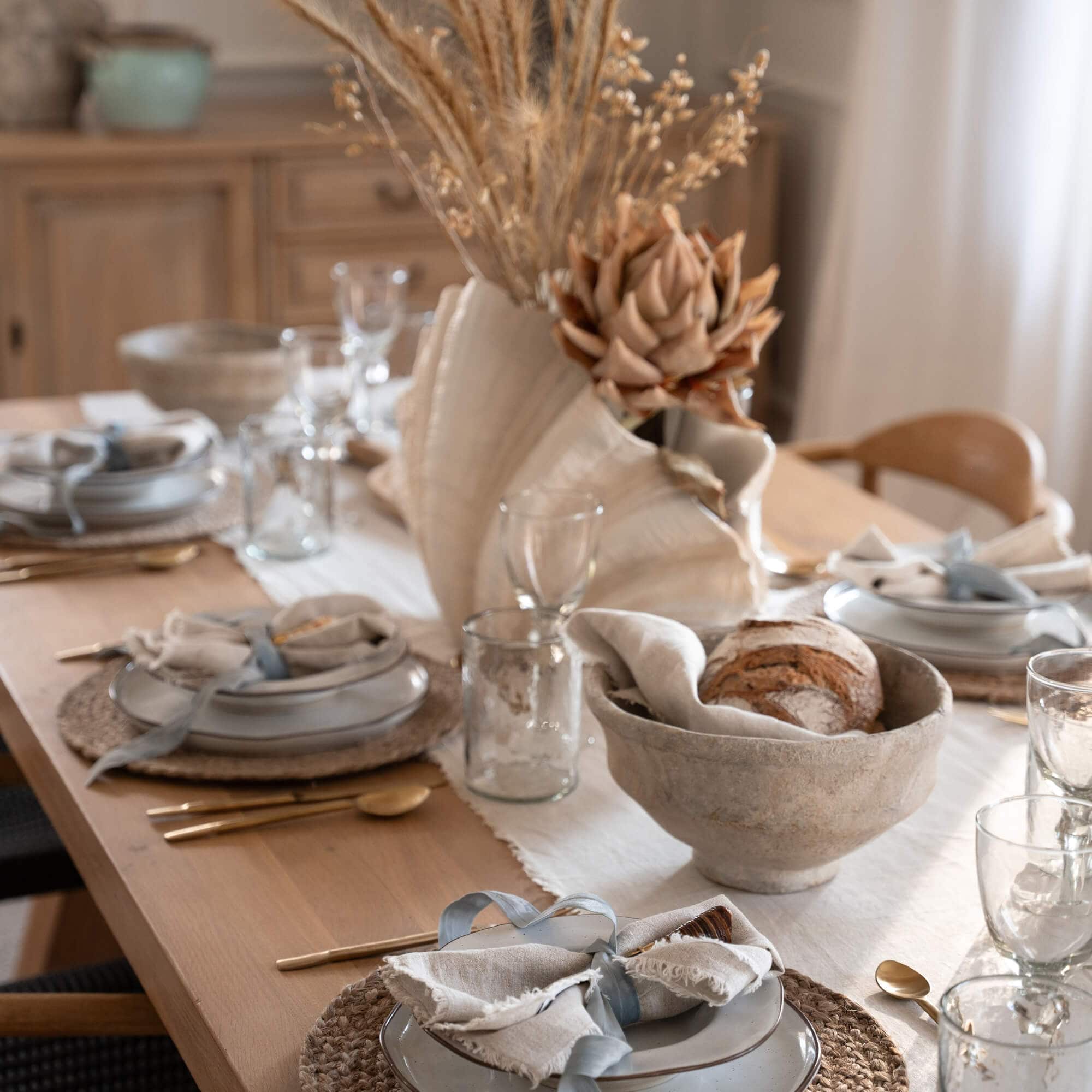 Table rustique en bois avec vaisselle en céramique et décoration florale séchée naturelle pour salle à manger
