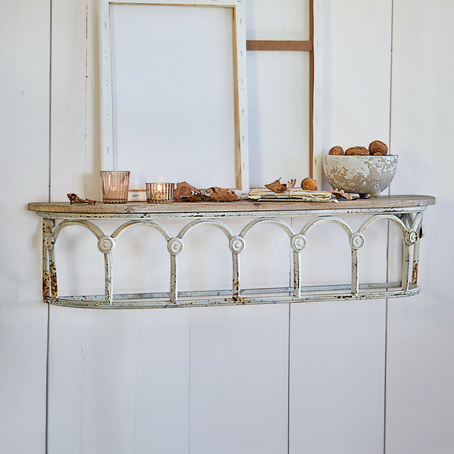 Étagère murale Espèche Étagère murale rustique en métal et bois blanc avec décorations et bougies allumées