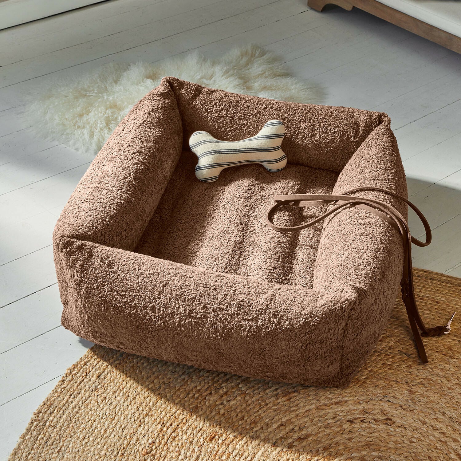 Lit pour animaux Giolena Panier pour chien en peluche marron avec coussin os rayé et laisse en cuir sur tapis tressé