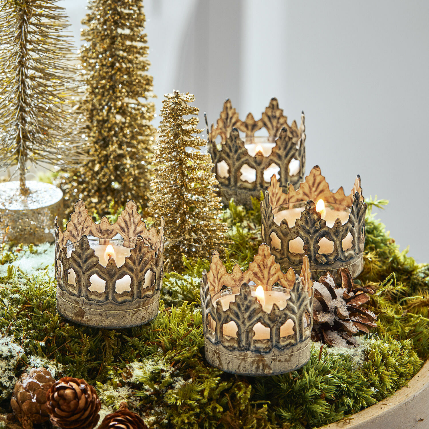 Lot de 4 photophores à piquer Groisy Photophores en métal en forme de couronne sur mousse verte avec décorations de Noël et bougies allumées