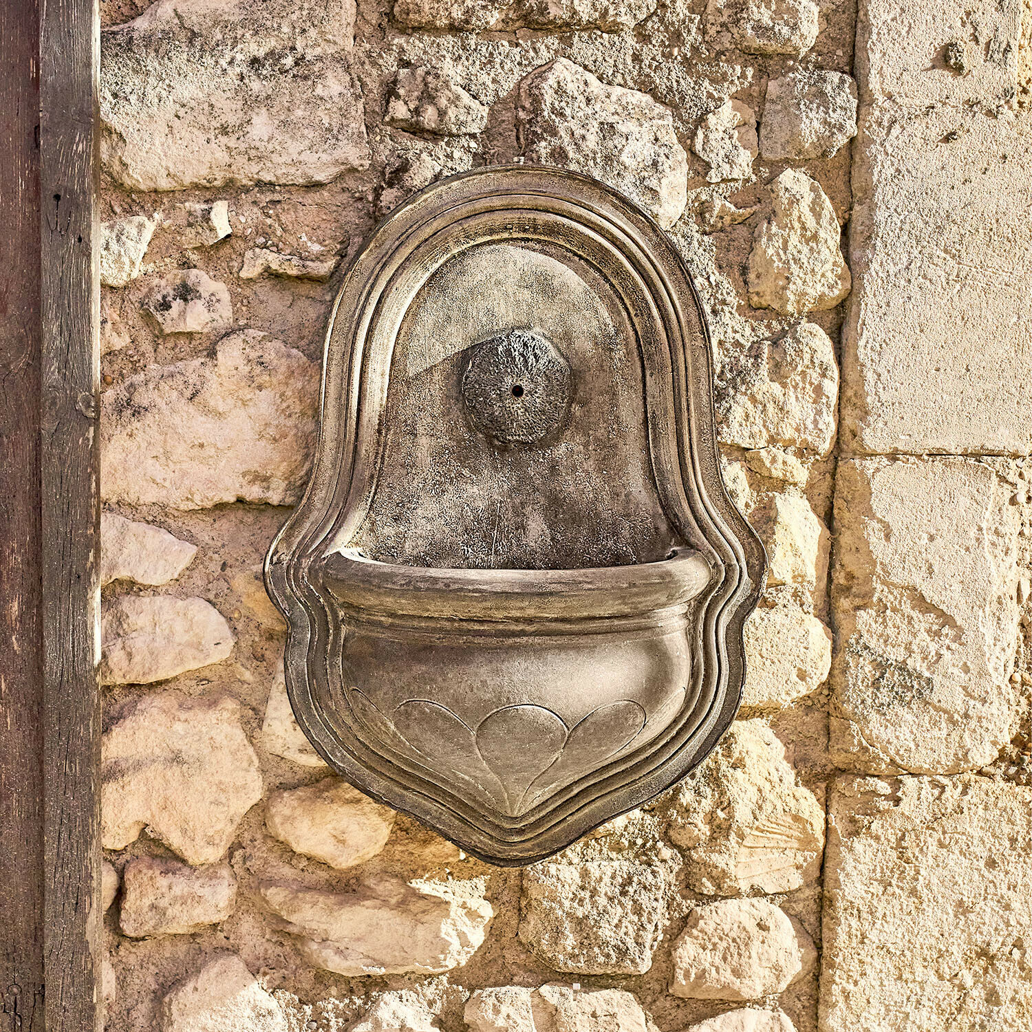 Fontaine murale Veliras Fontaine murale décorative en pierre grise fixée sur un mur en pierres, décoration extérieure
