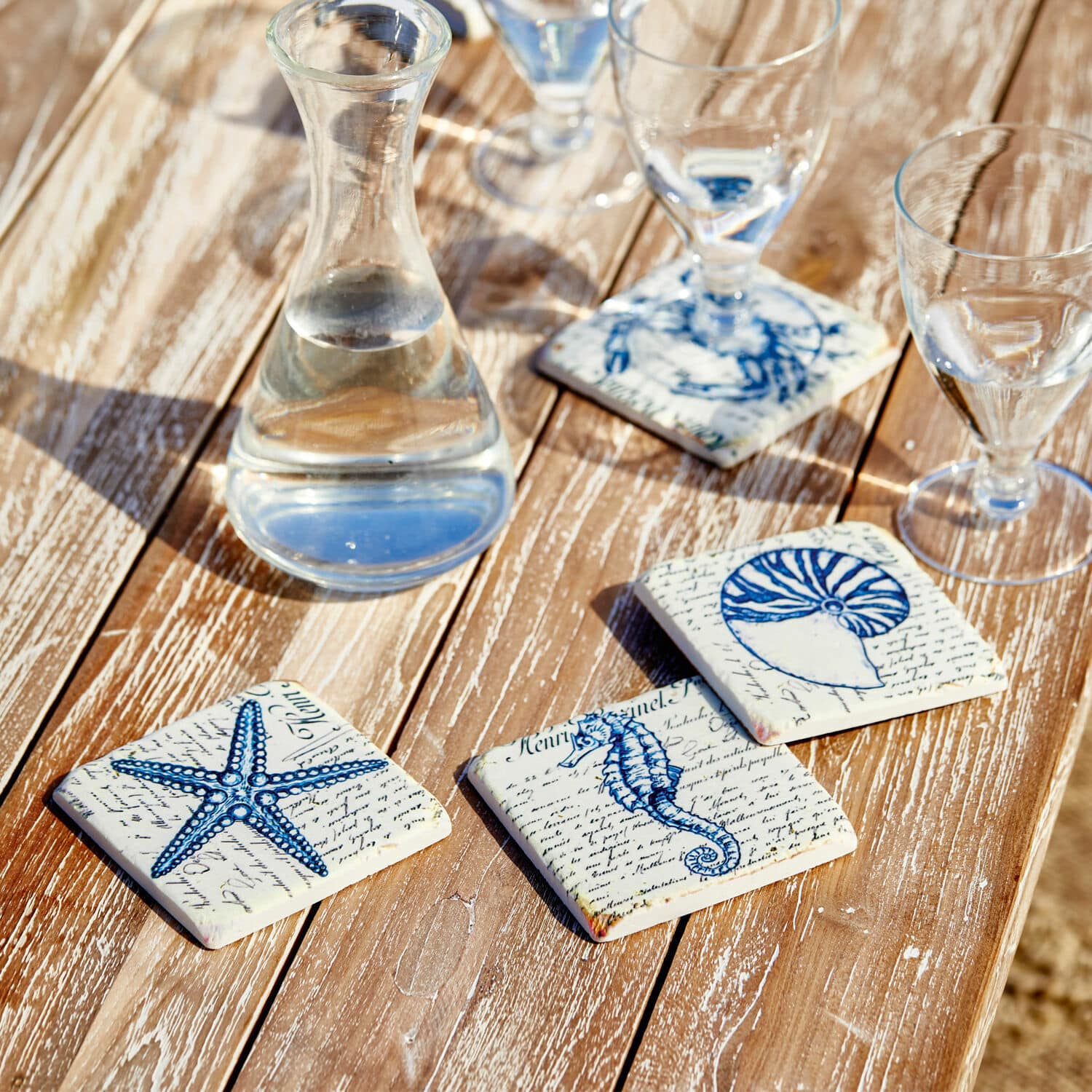 Lot de 4 dessous de verres Faune Marine Dessous de verre en céramique avec motifs marins bleus sur table en bois, décoration de table élégante