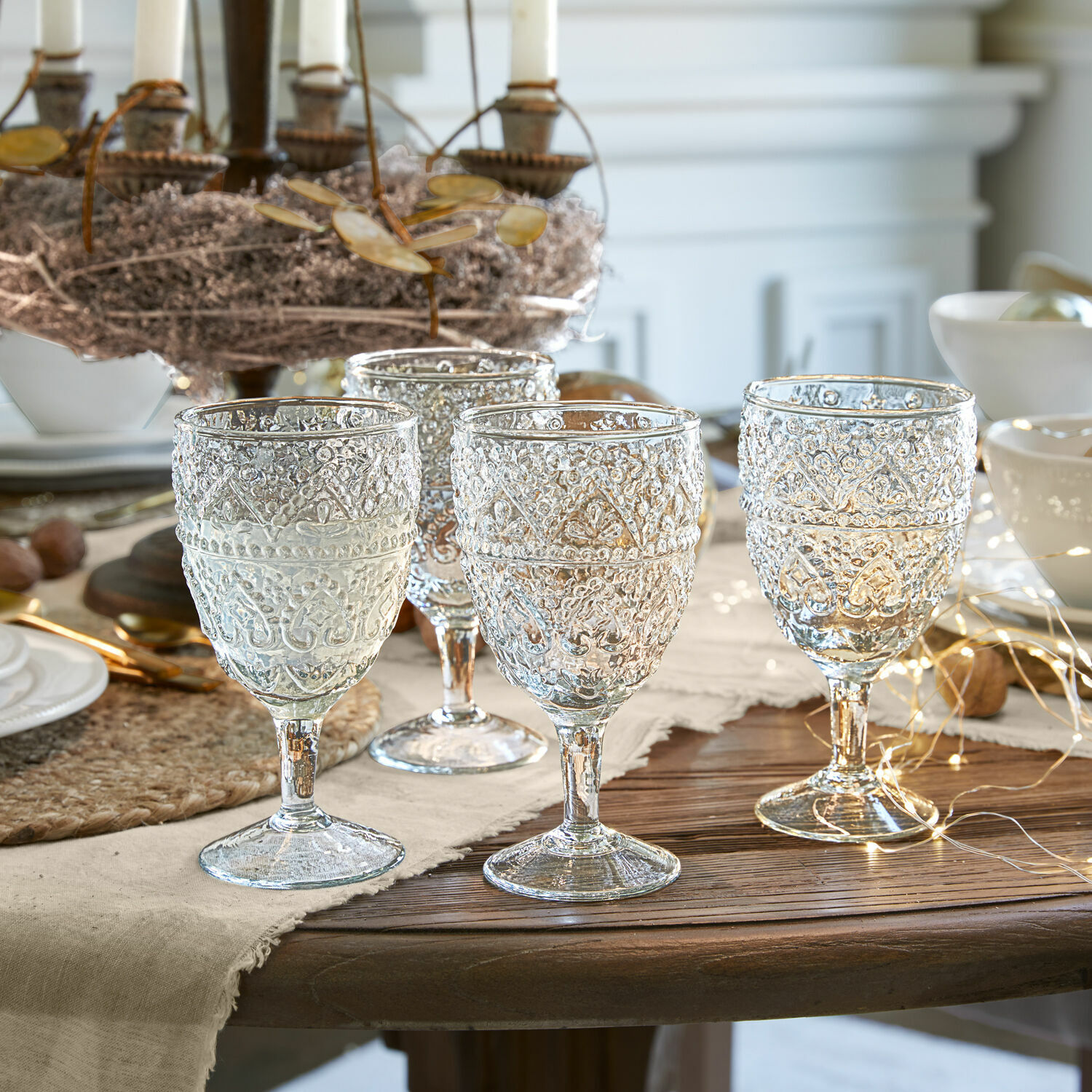 Lot de 4 verres Ivrecourt Ensemble de quatre verres transparents avec motif décoratif sur table en bois avec décoration festive