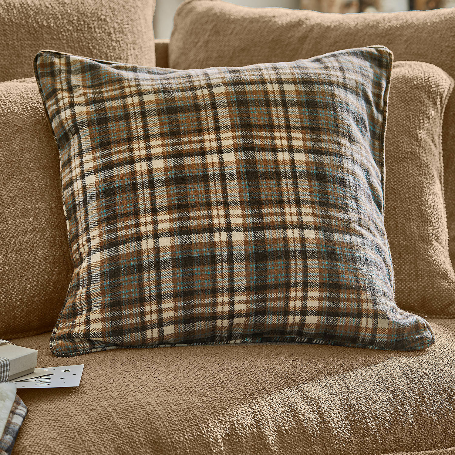 Housse de coussin Celestria Coussin à carreaux marron et crème en tissu doux sur canapé beige, décoration intérieure cosy