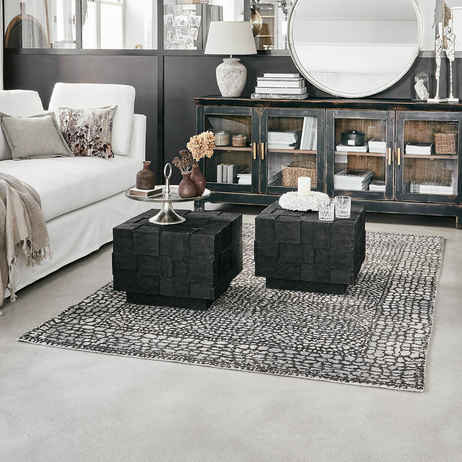 Tapis Vermont Salon moderne avec canapé blanc et tables basses en bois noir sur tapis à motifs