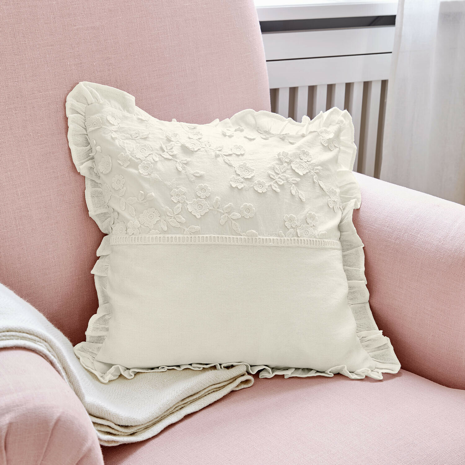 Housse de coussin Lunérie Coussin décoratif blanc avec broderie florale et volant sur fauteuil rose, tissu doux