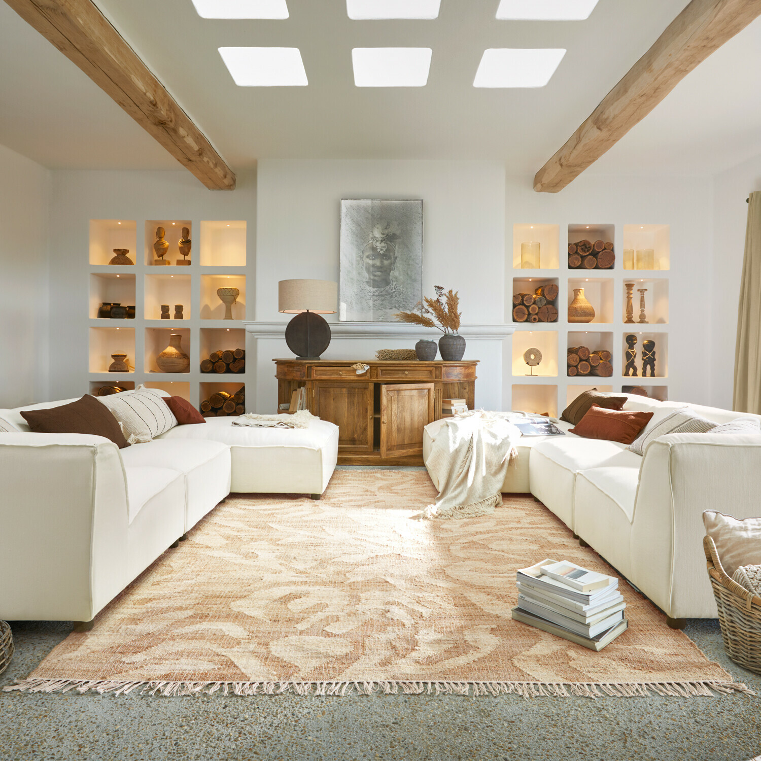 Salon chaleureux avec canapé blanc, buffet en bois et décorations en bois, tapis beige à motifs