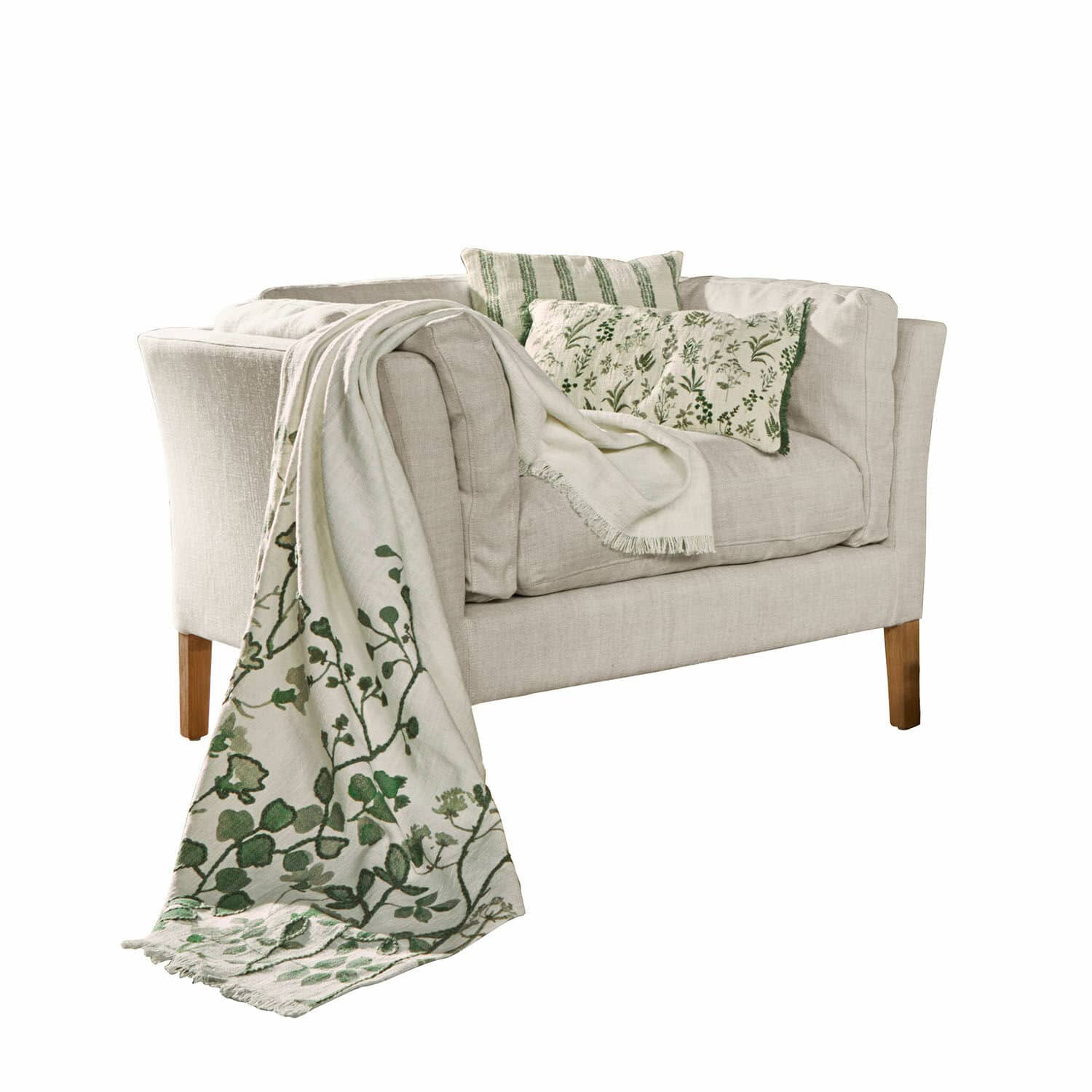 Fauteuil Lourvière Canapé beige en tissu avec coussins verts et plaid décoratif à motif végétal