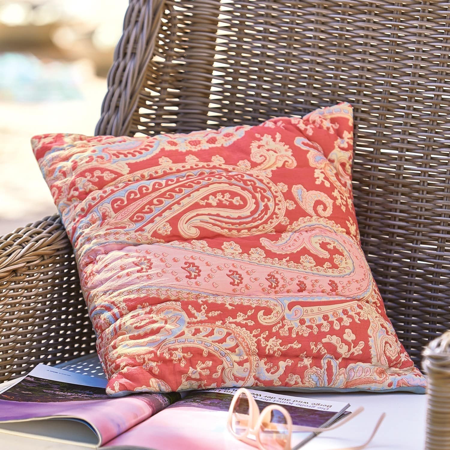 Housse de coussin Aram Coussin décoratif en coton rouge avec motif paisley sur fauteuil en osier pour salon extérieur