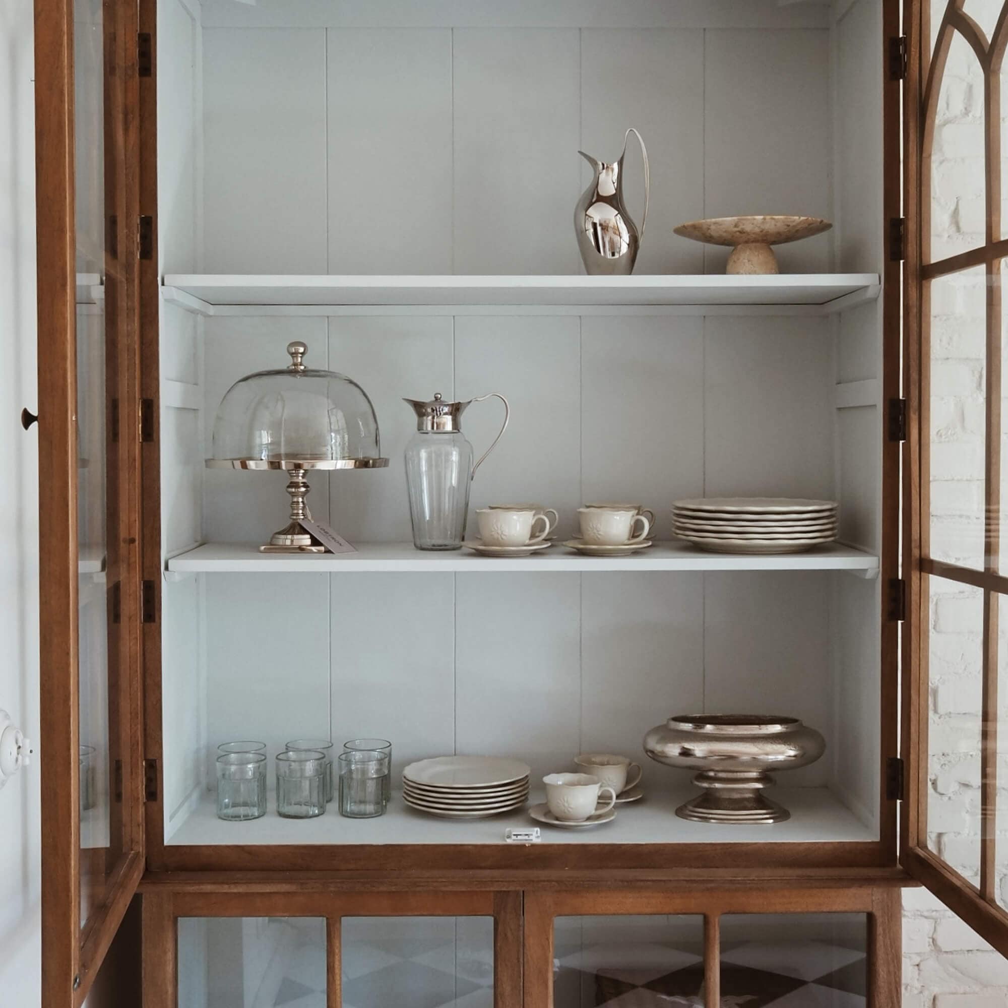 Vitrine en bois avec étagères blanches, vaisselle en porcelaine et verres en verre pour la maison