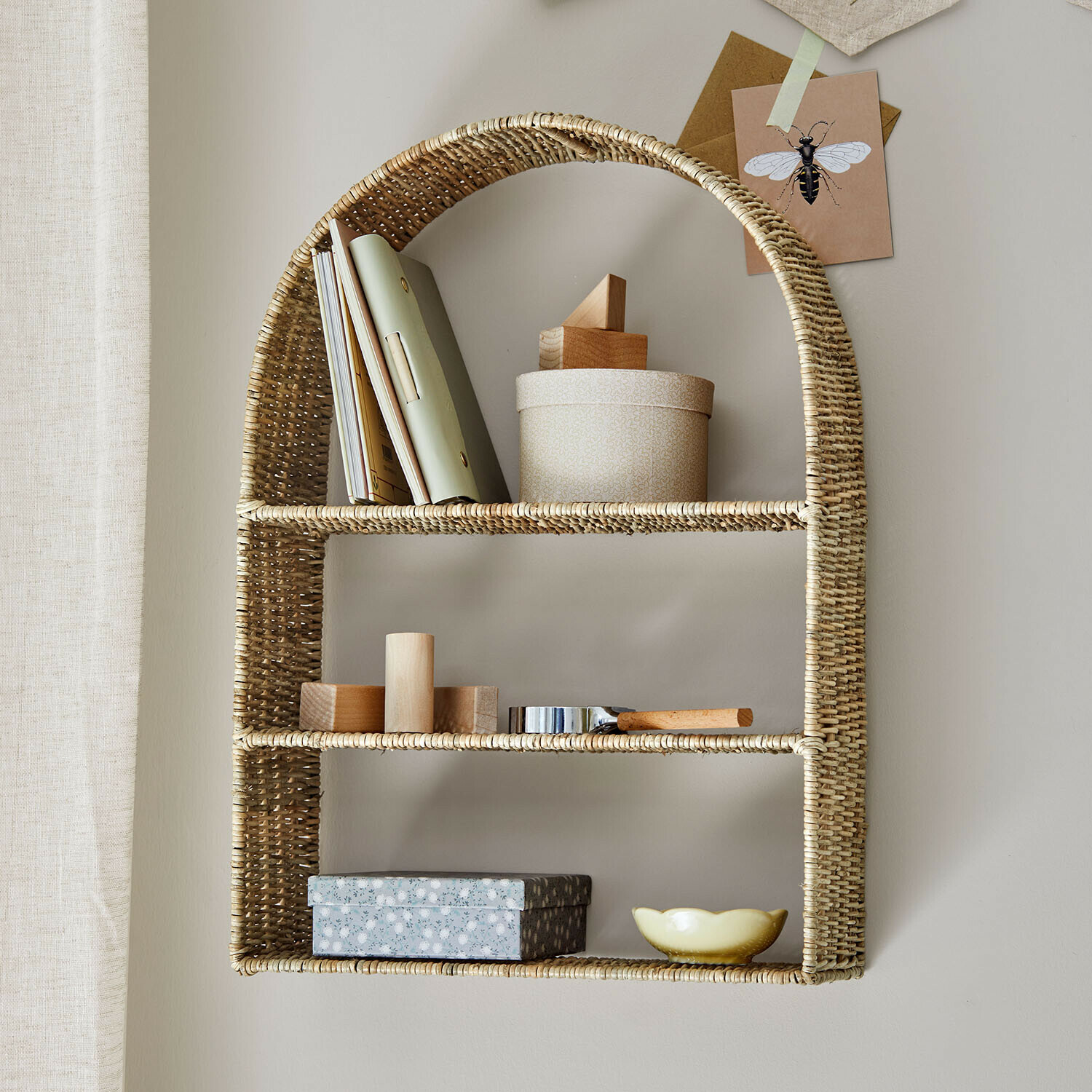 Étagère murale en rotin naturel avec décorations et livres pour rangement pratique