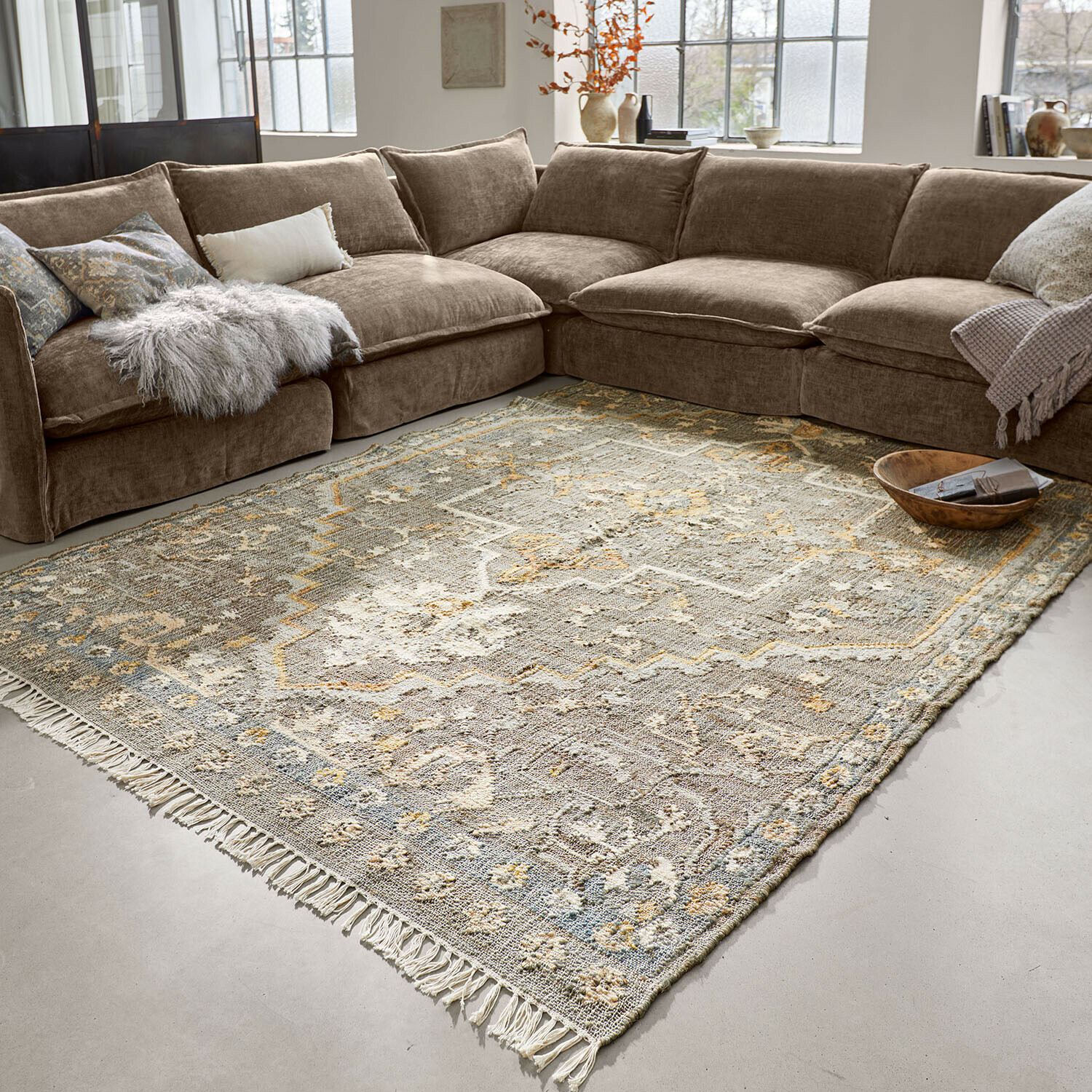 Tapis Brenrin Grand canapé d'angle marron en tissu doux dans un salon moderne avec tapis vintage
