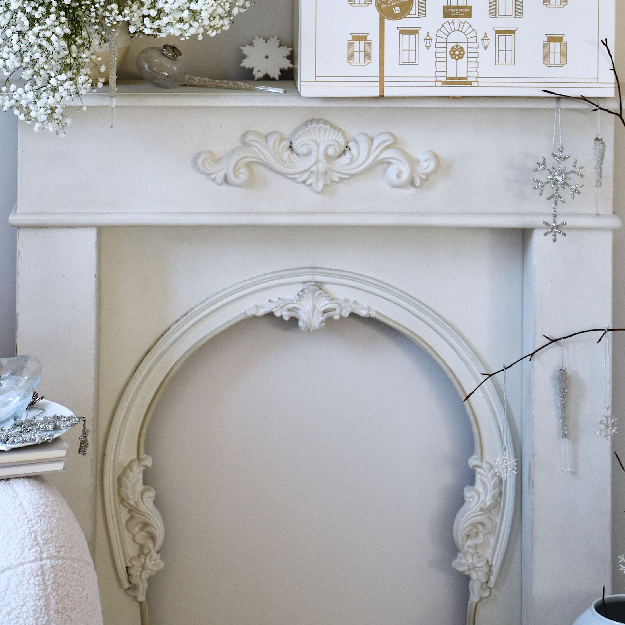 Console de cheminée blanche avec ornements sculptés et décorations de Noël vintage