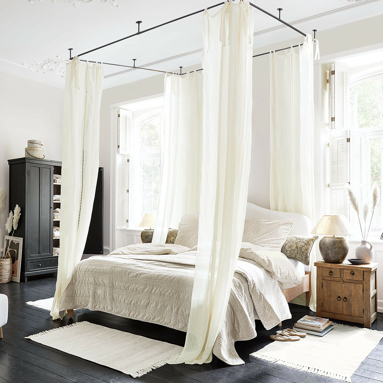 Rideau Elorine Chambre avec lit à baldaquin en coton blanc et literie beige sur parquet foncé, ambiance lumineuse naturelle