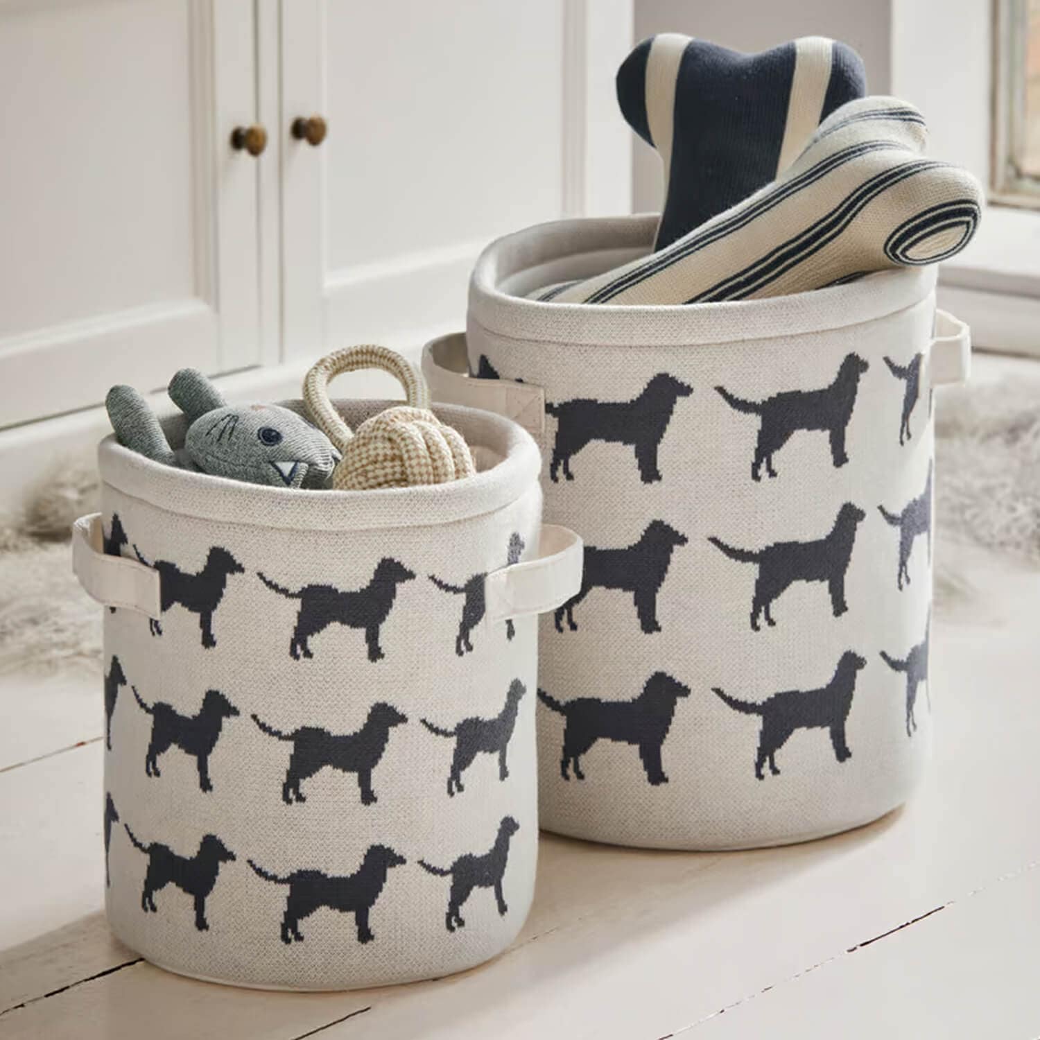 Paniers en coton beige avec motif chien noir, parfaits pour ranger jouets et accessoires.