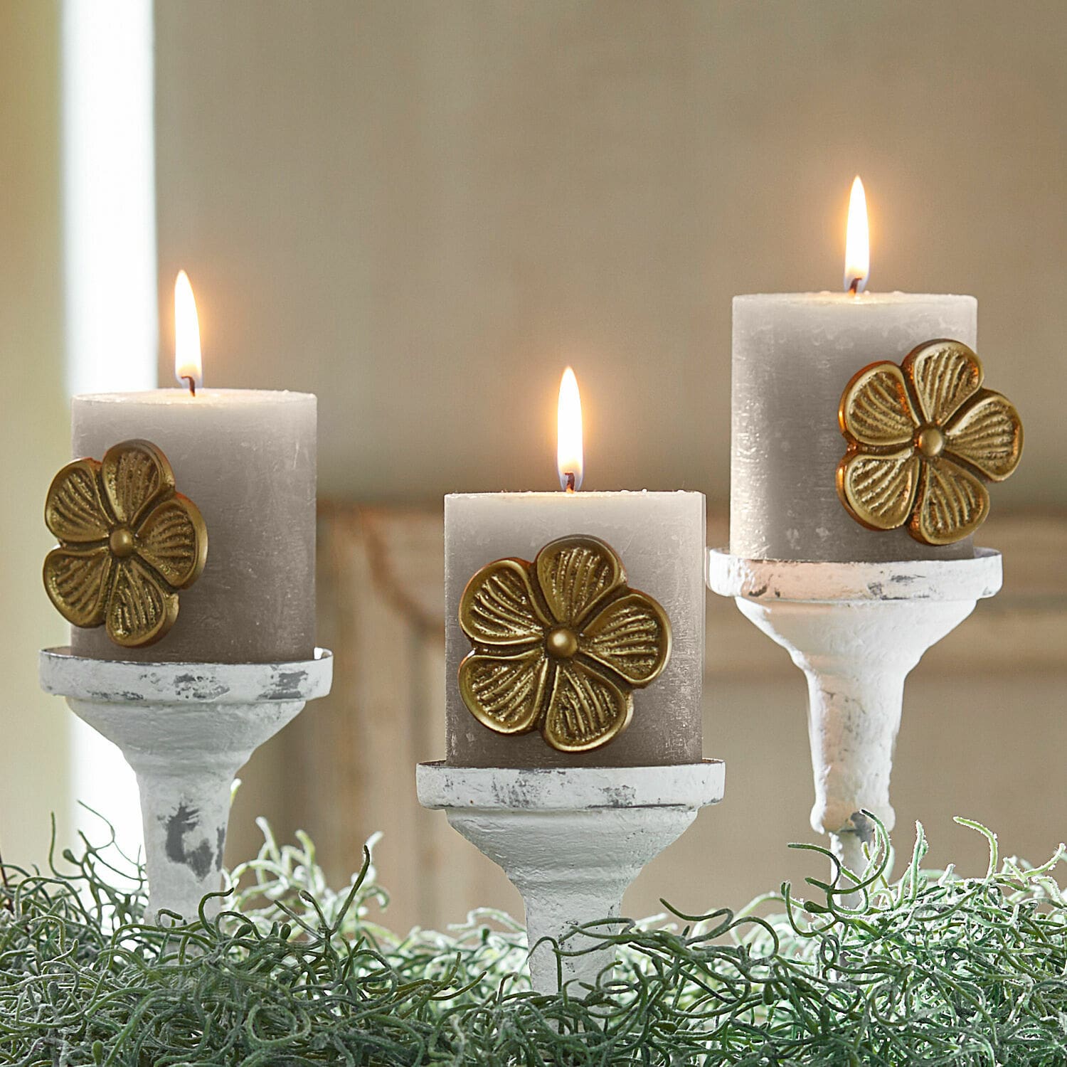 Lot de 3 pin’s décoratifs Olevir Trois bougies grises avec décoration fleur dorée sur des chandeliers blancs entourés de feuillage vert