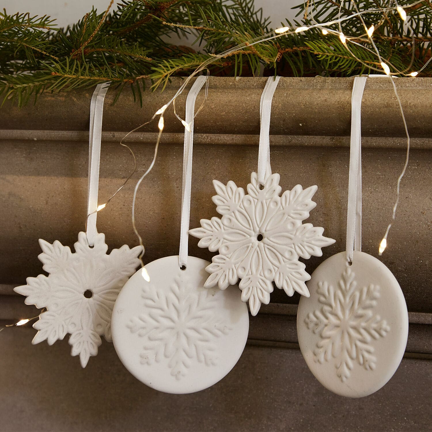 Lot de 4 décorations à suspendre Jorval Décorations de Noël en céramique blanche en forme de flocons de neige avec rubans et lumières LED