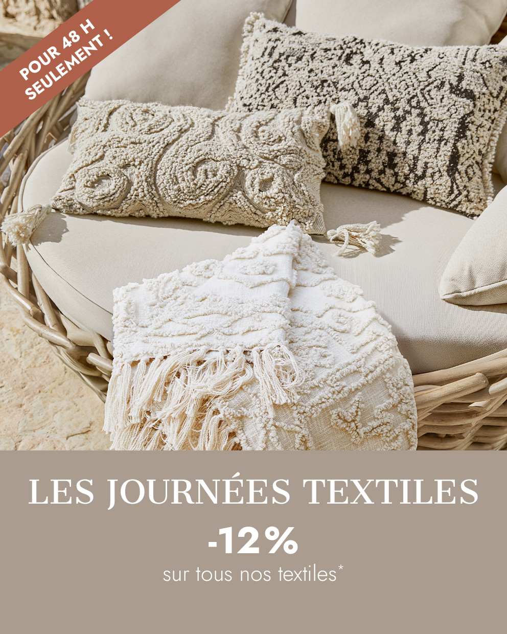 Coussins décoratifs beiges et plaid à franges sur canapé en osier, textiles d'intérieur