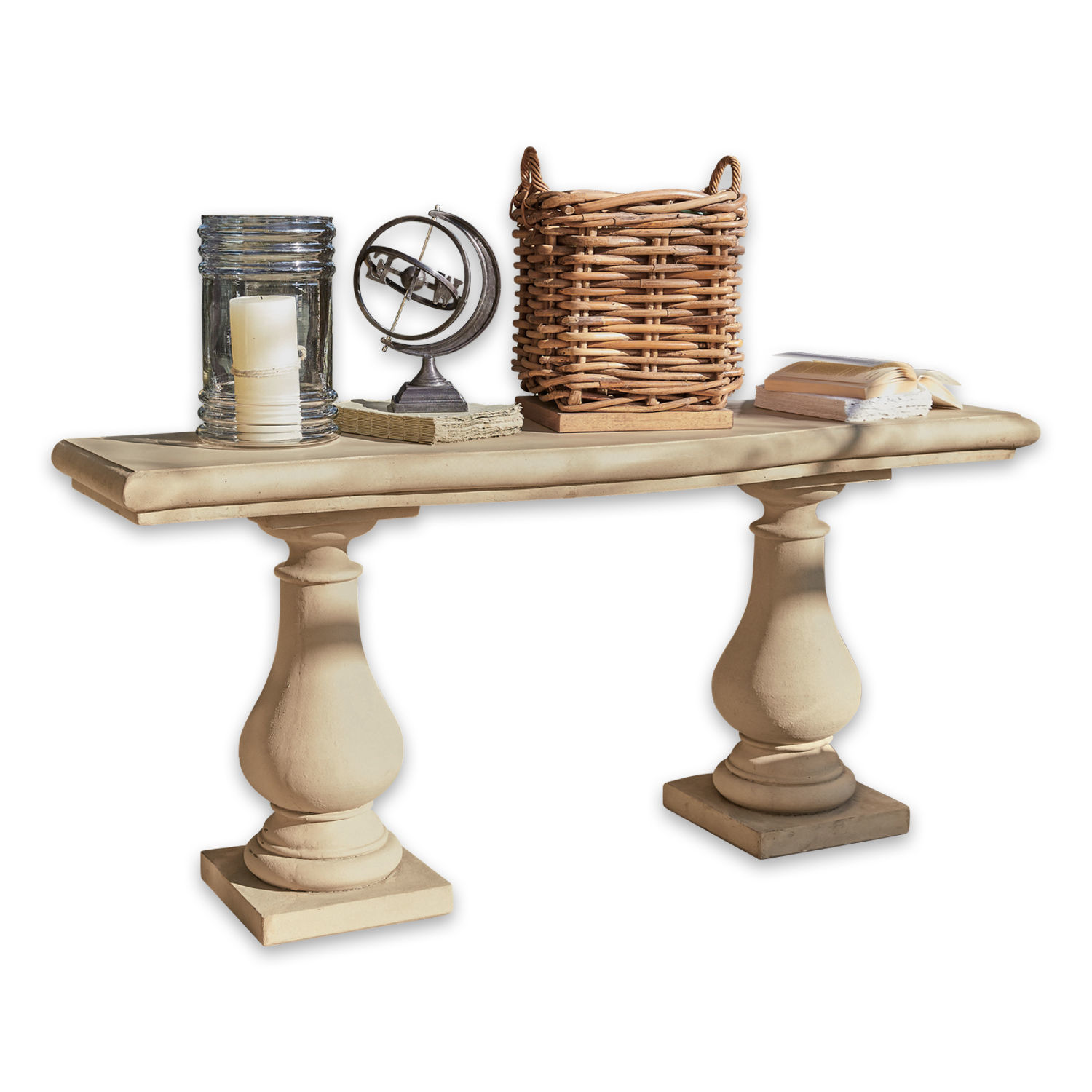 Console Carrington Table beige en pierre avec deux pieds sculptés, décorée d'une bougie, de livres et d'un panier en osier